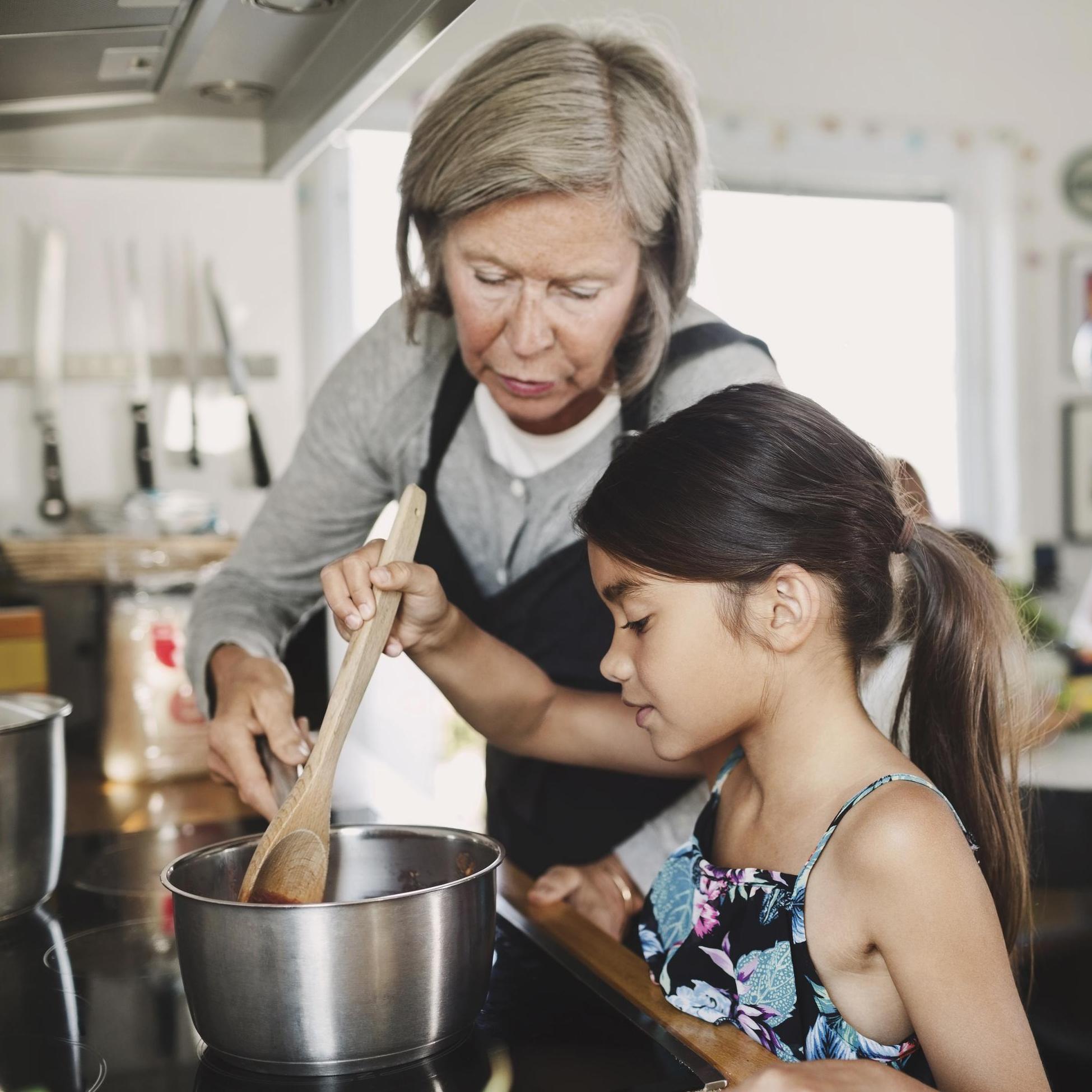 Grandmother and grandchild cooking together